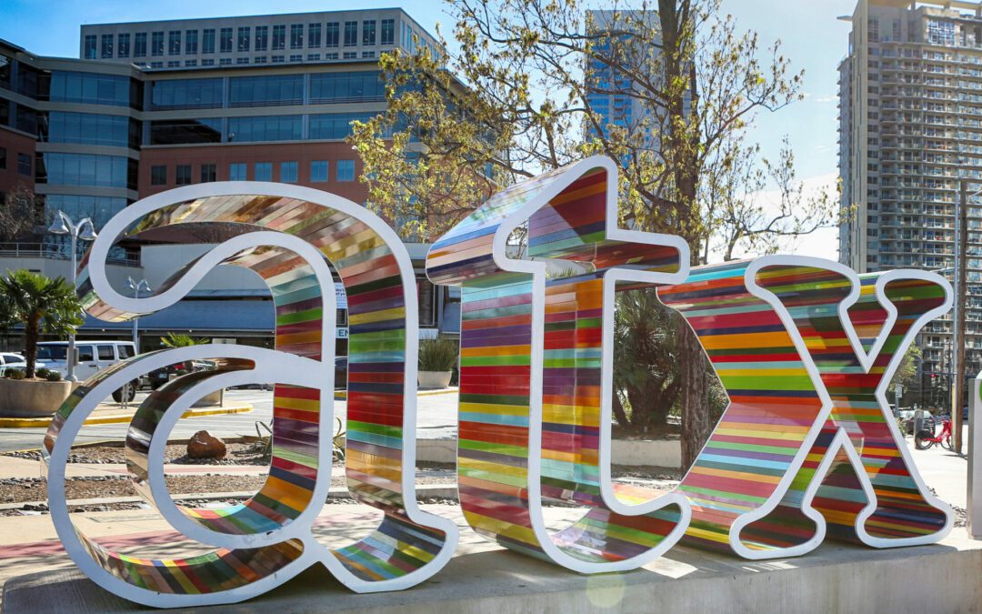 Colorful "ATX" sculpture in an urban setting.