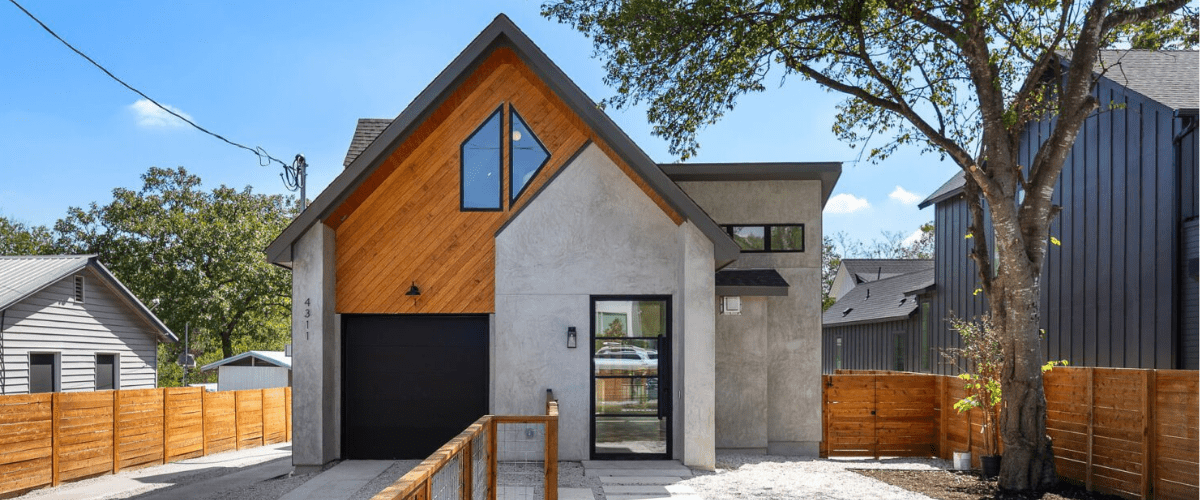 Modern backyard with a rectangular pool, artificial grass, and a stylish two-story home with a metal exterior.