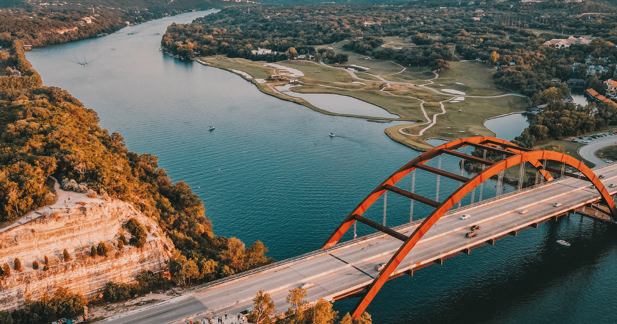 5 Austin skyline with bridge and river.